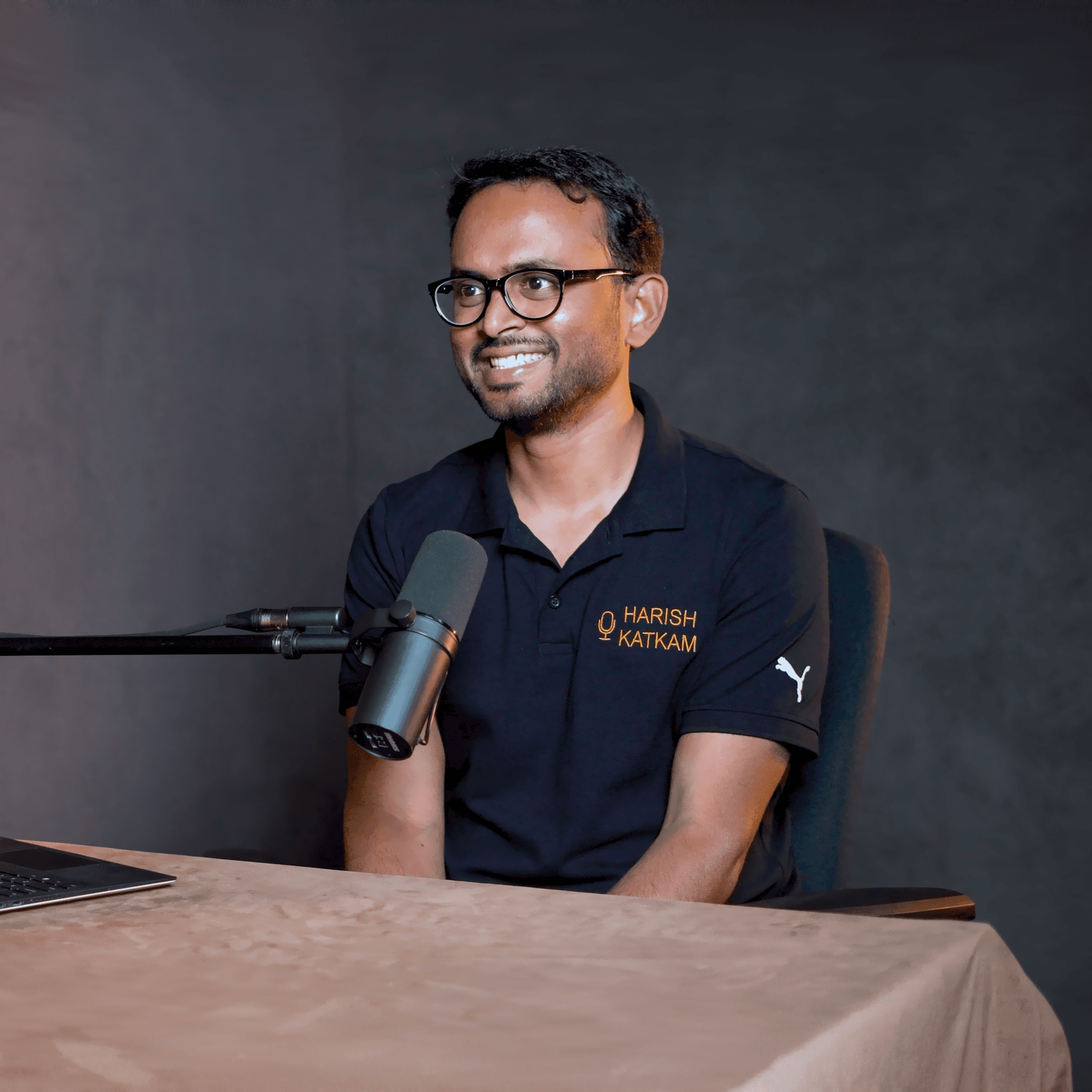 Harish Katkam, host of the podcast, sitting in front of a microphone